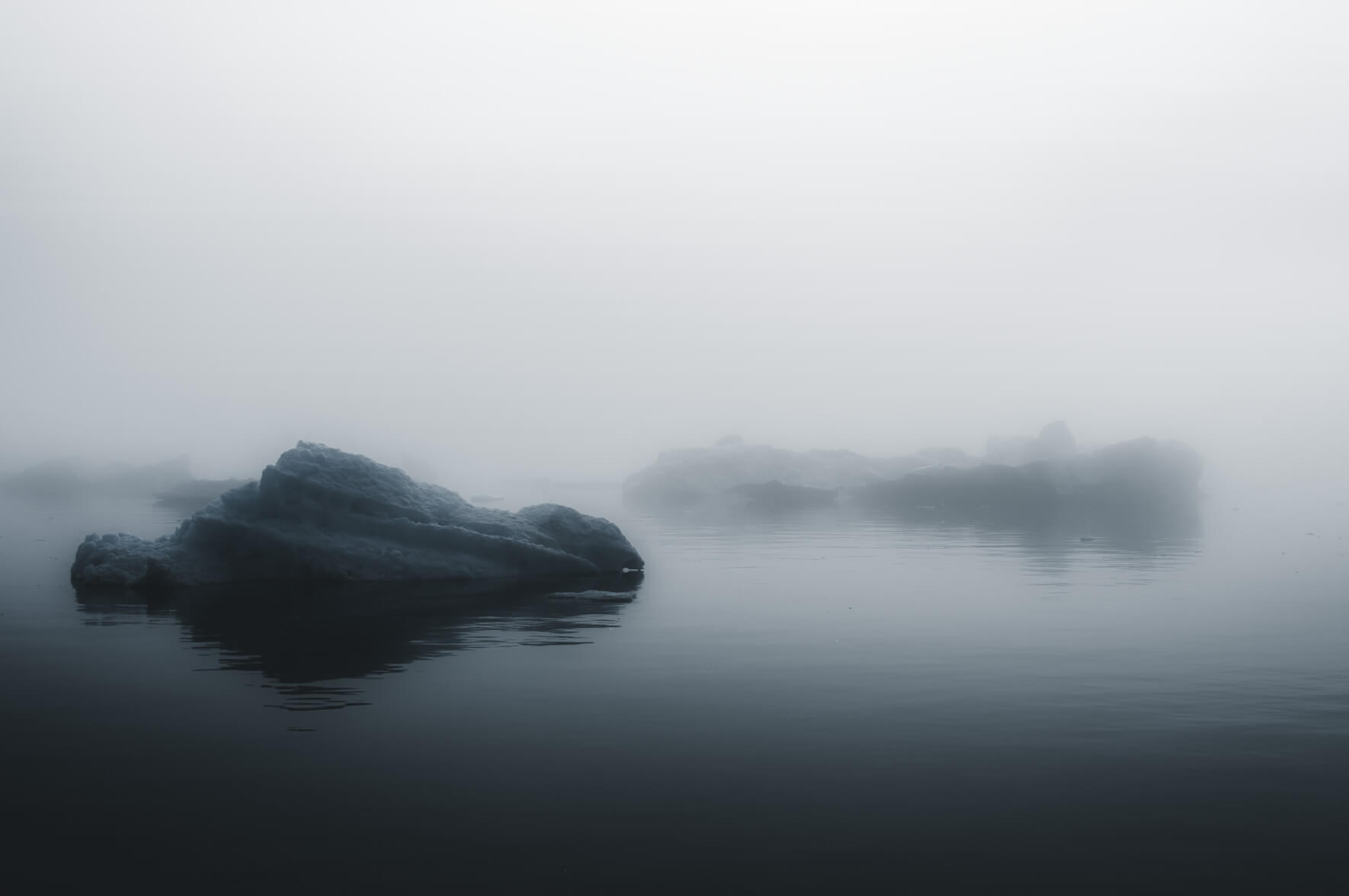 Small icebergs floating in foggy weather (Disko Bay, Greenland)