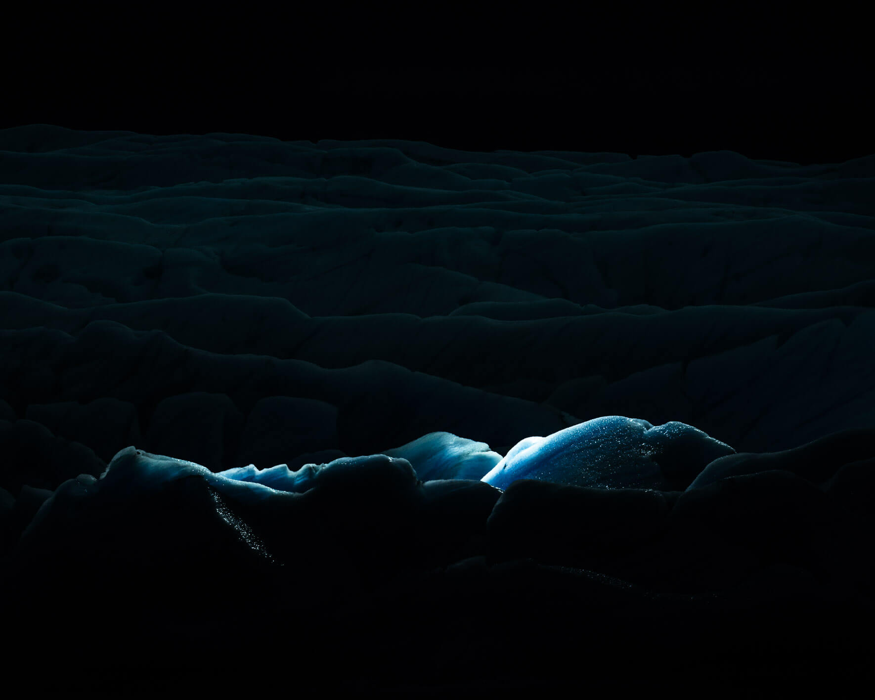 Svínafellsjökul glacier at night illuminated with aerial LED lights