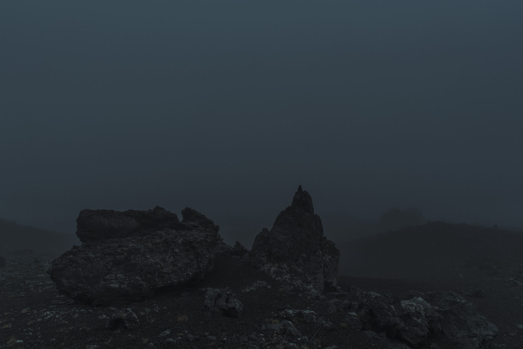 Dark silhouettes of rocks in the Highlands of Iceland at dusk