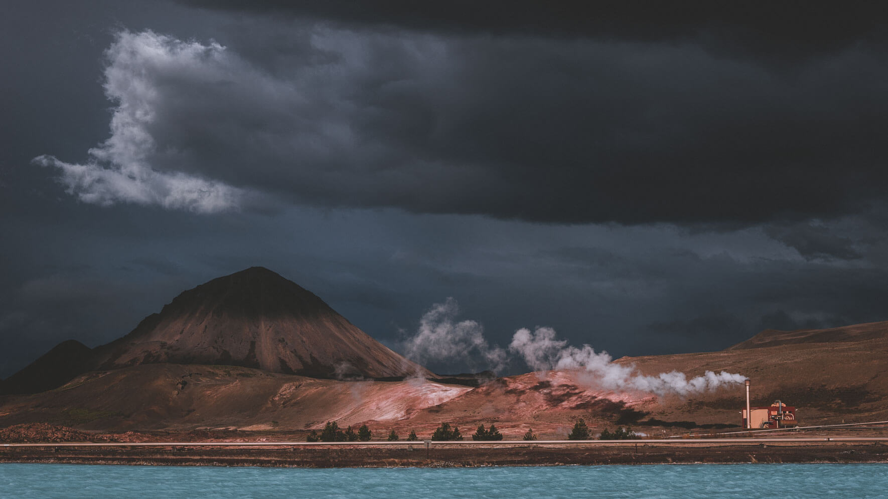 Dark clouds over geothermal power plant near lake Myvatn in Iceland