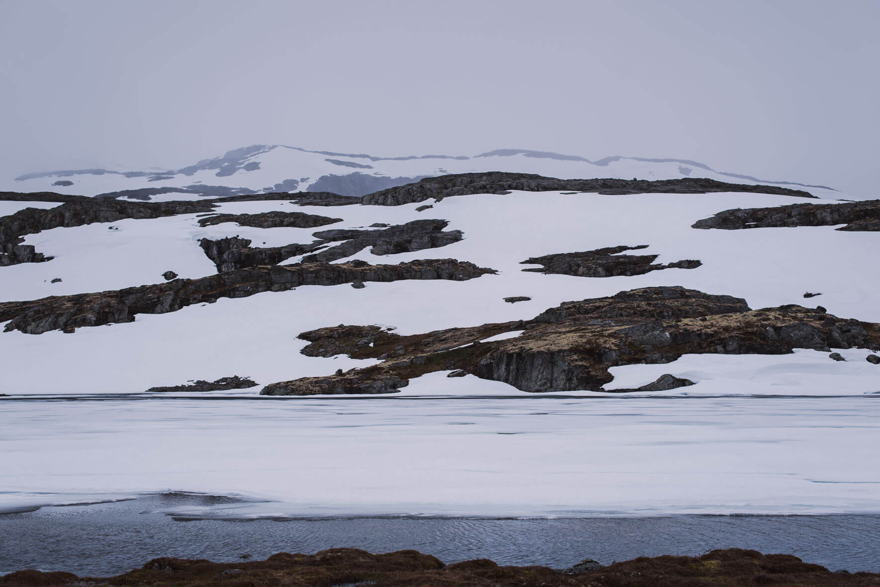 Frozen lake and mountains on the Sogn og Fjordane County Road 243 (Snøvegen) in Norway