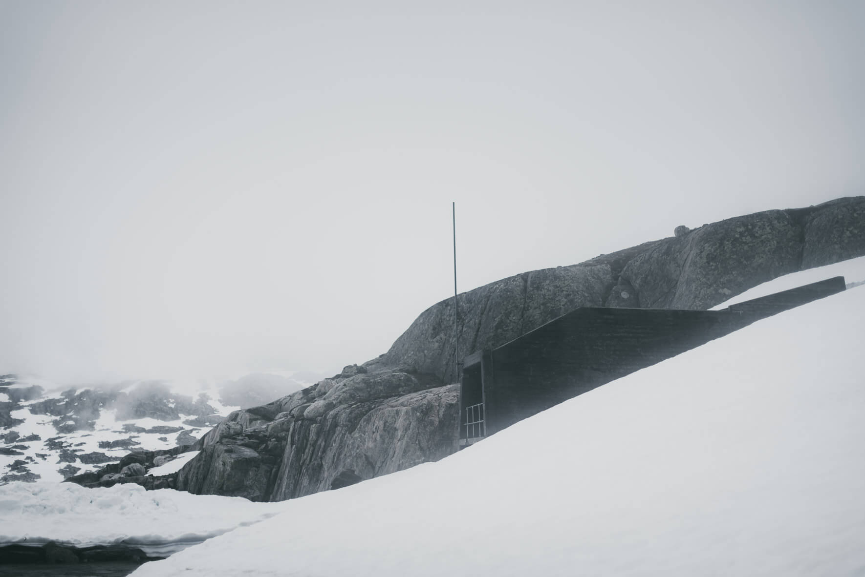 Rocks and dam architecture at the glacial lake Styggevatnet in Norway