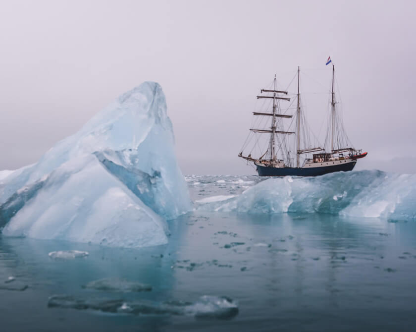 SV Antigua along the coast of Svalbard (Norway) with icebergs