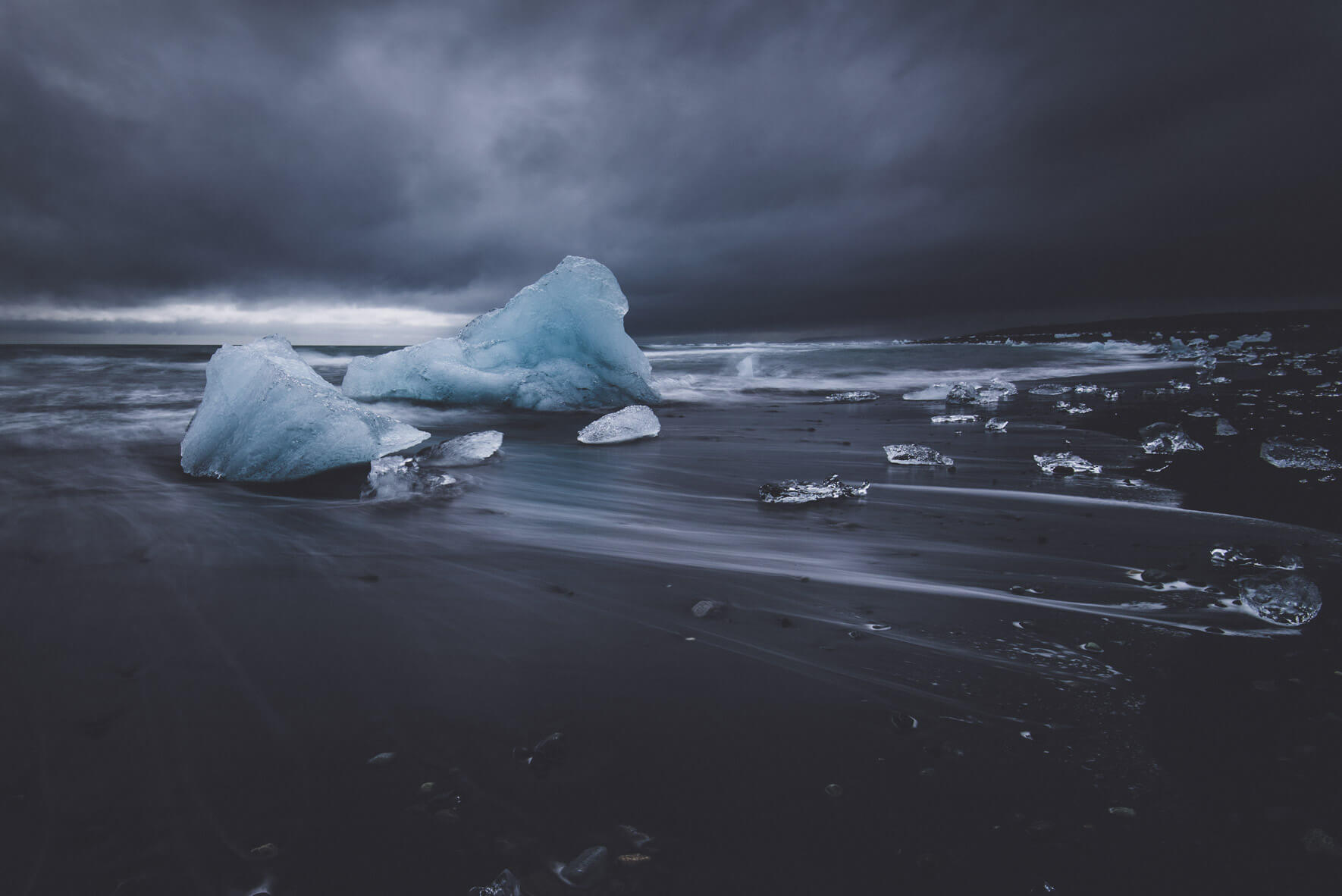 Stranded icebergs on the black sand beach of Jökulsárlón glacier lagoon